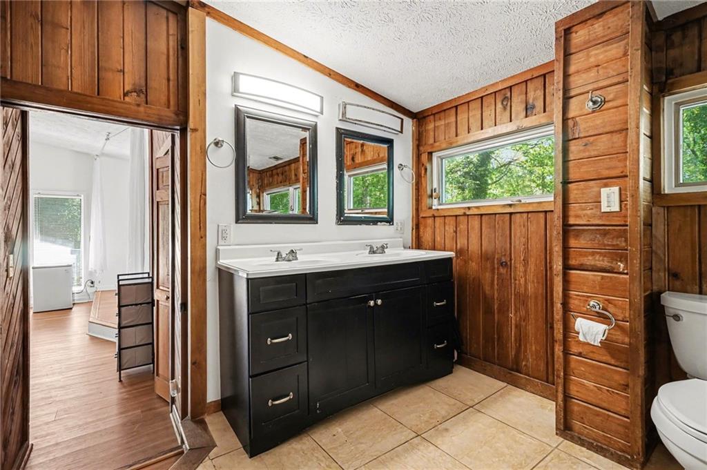 2530 Rockbridge Road Northwest Conyers, GA 30012 - Photo 22 of 45 a bathroom with a double vanity sink toilet and shower