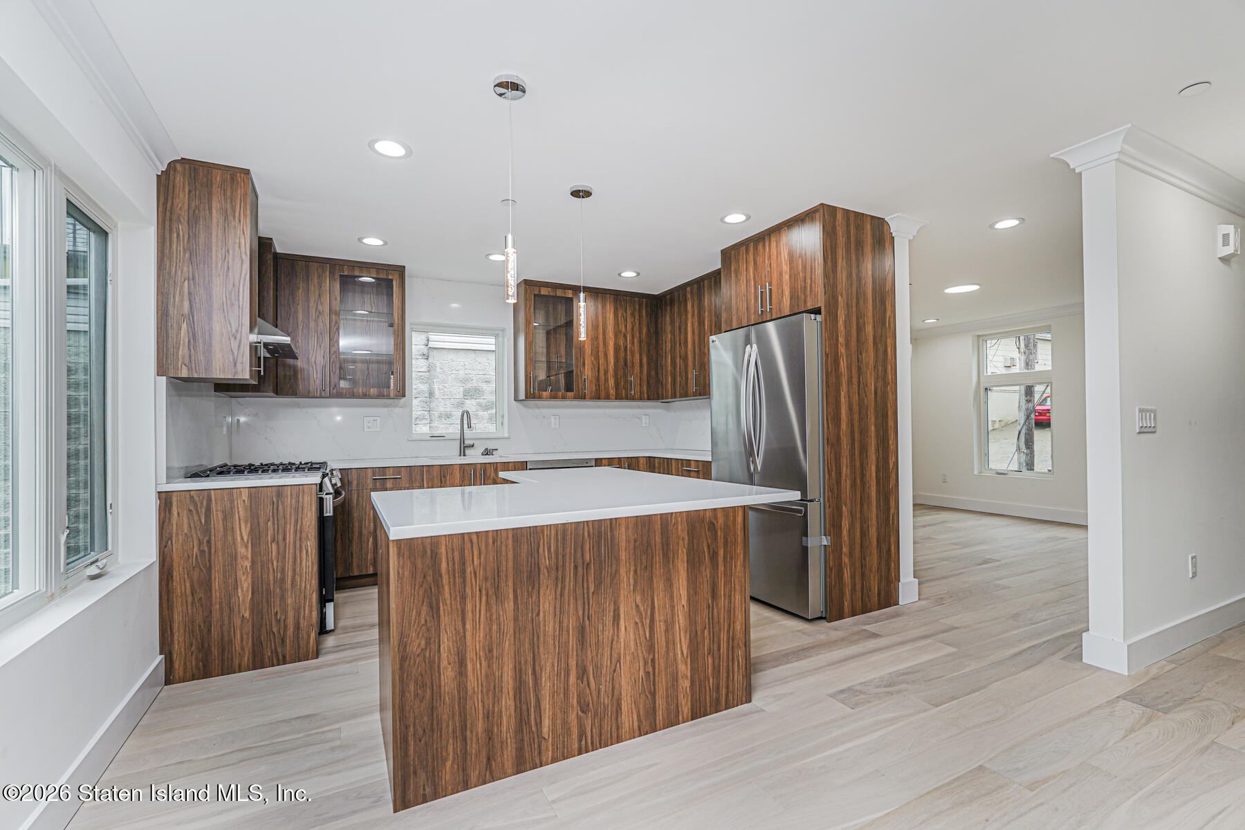 54 Cedarcliff Road Staten Island, NY 10301 - Photo 9 of 49 a kitchen with stainless steel appliances granite countertop a refrigerator a sink dishwasher and wooden cabinets with wooden floor