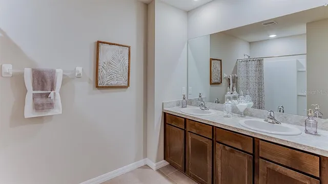 a bathroom with a double vanity sink and a mirror