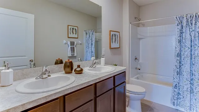 a bathroom with a sink toilet tub and shower