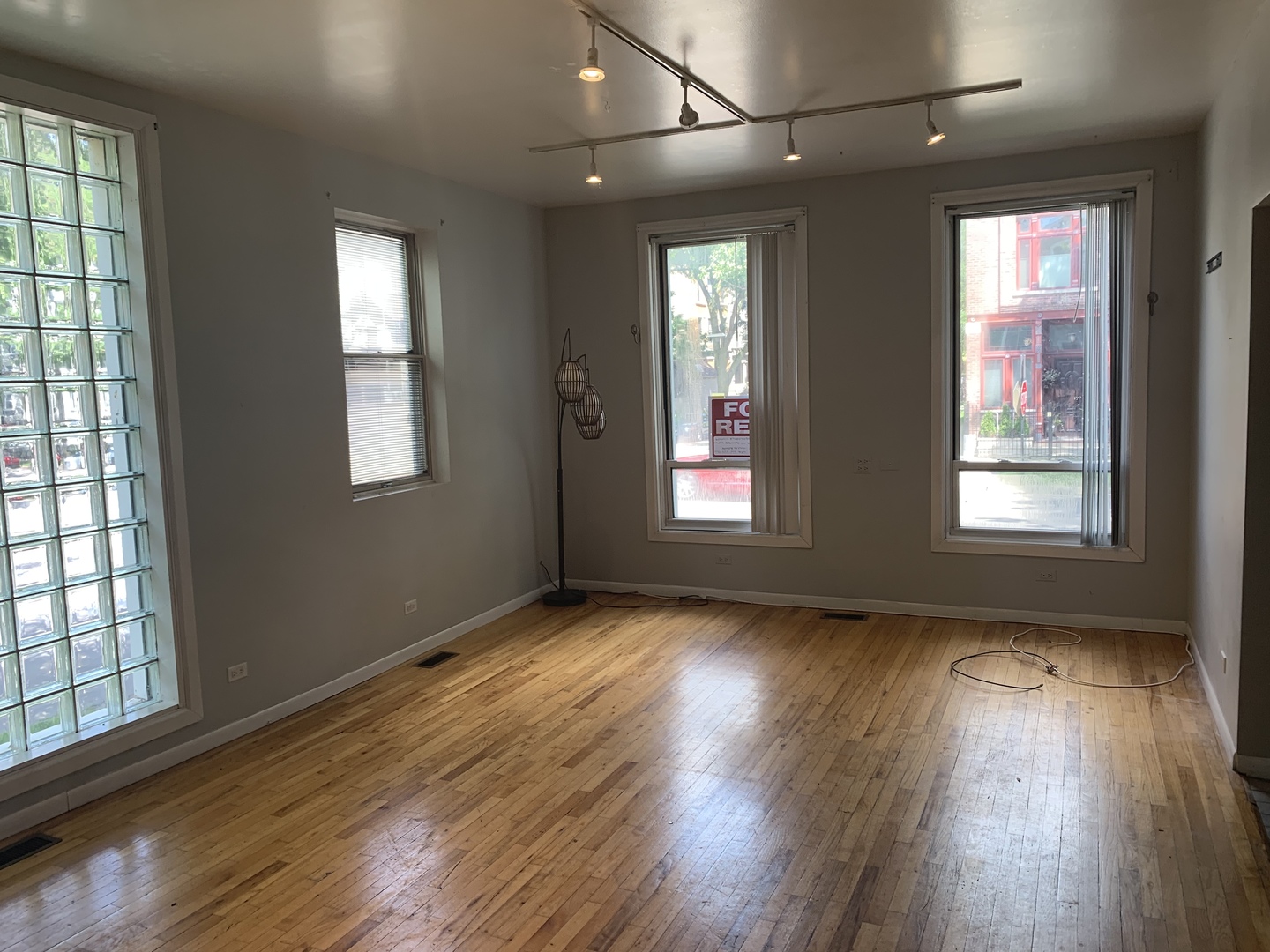 Undisclosed Address Chicago, IL 60657 - Photo 3 of 11 a view of an empty room with wooden floor and a window