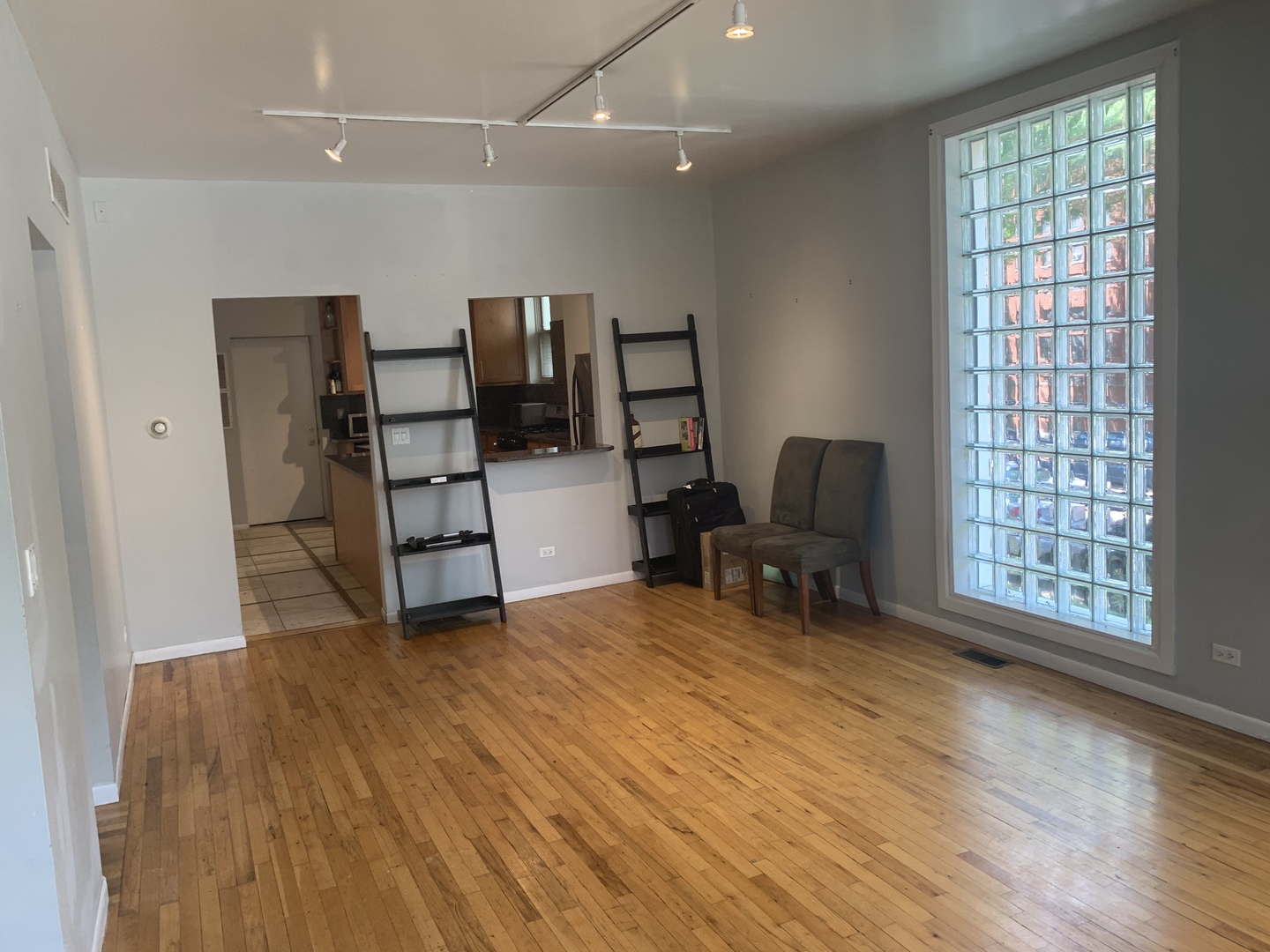 Undisclosed Address Chicago, IL 60657 - Photo 4 of 11 an empty room with furniture and windows