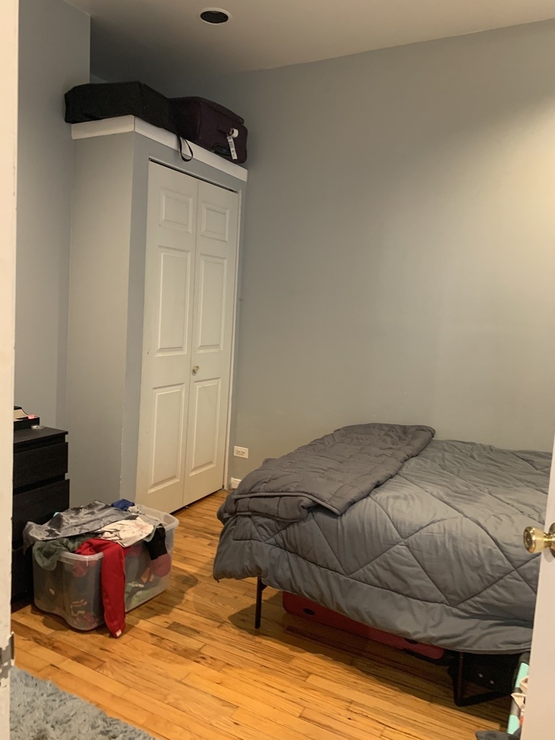 Undisclosed Address Chicago, IL 60657 - Photo 5 of 11 a bedroom with a bed and a window