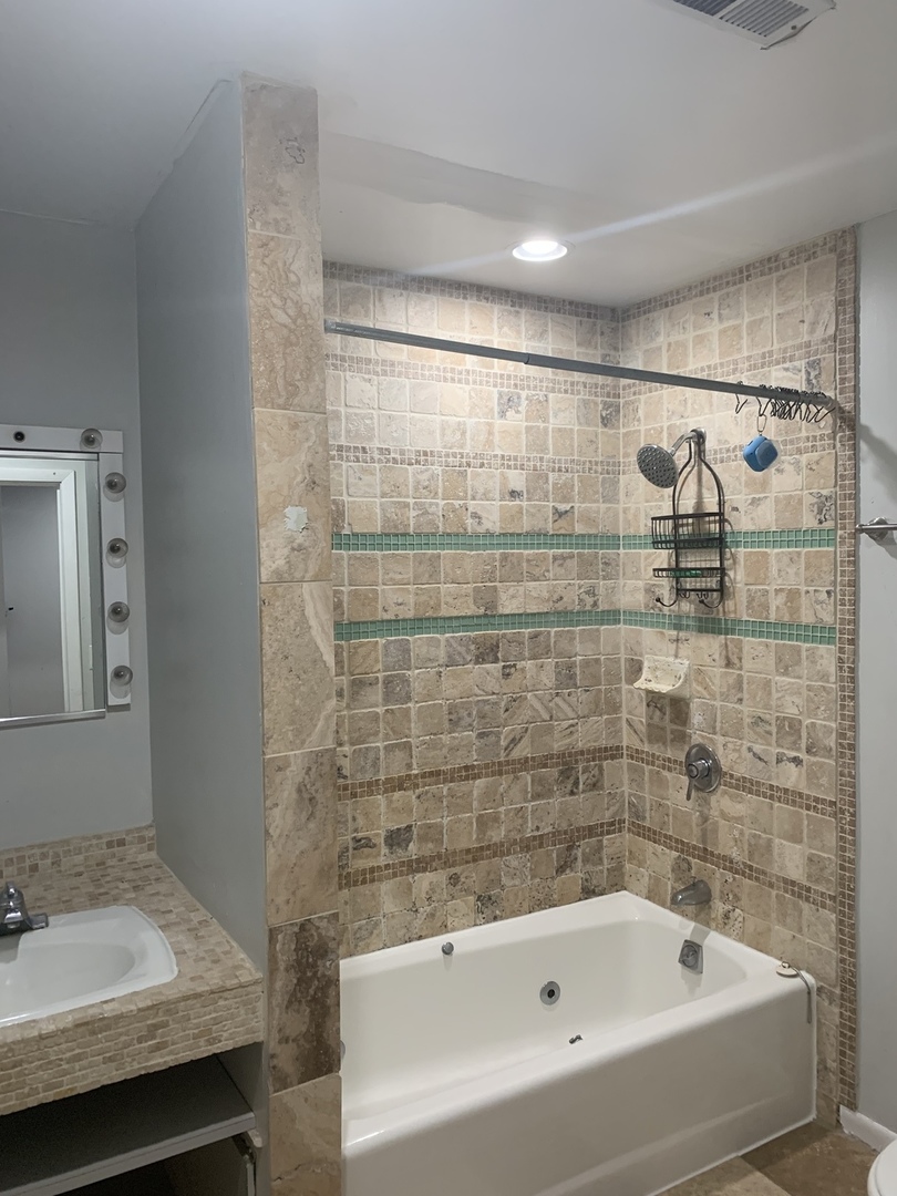 Undisclosed Address Chicago, IL 60657 - Photo 7 of 11 a bathroom with a bathtub and shower