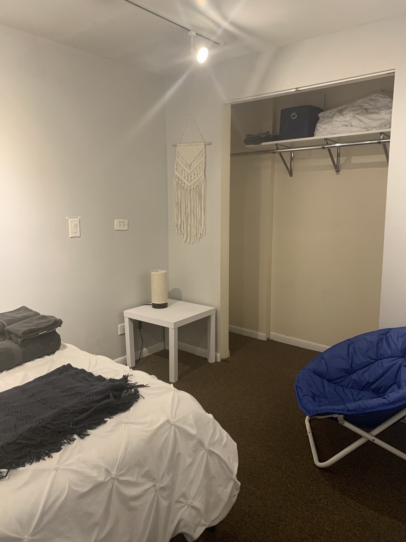 Undisclosed Address Chicago, IL 60657 - Photo 10 of 11 a bedroom with a bed and a chair