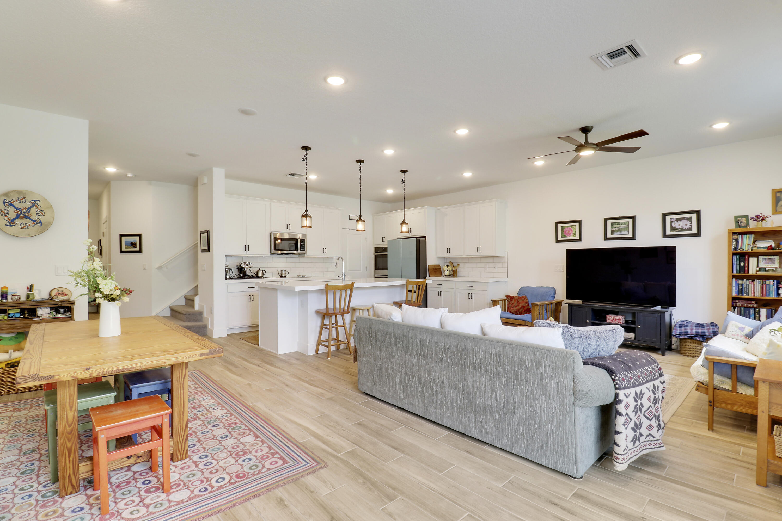 1416 Gopher Terrace Stuart, FL 34994 - Photo 13 of 53 a living room with furniture a flat screen tv and kitchen view