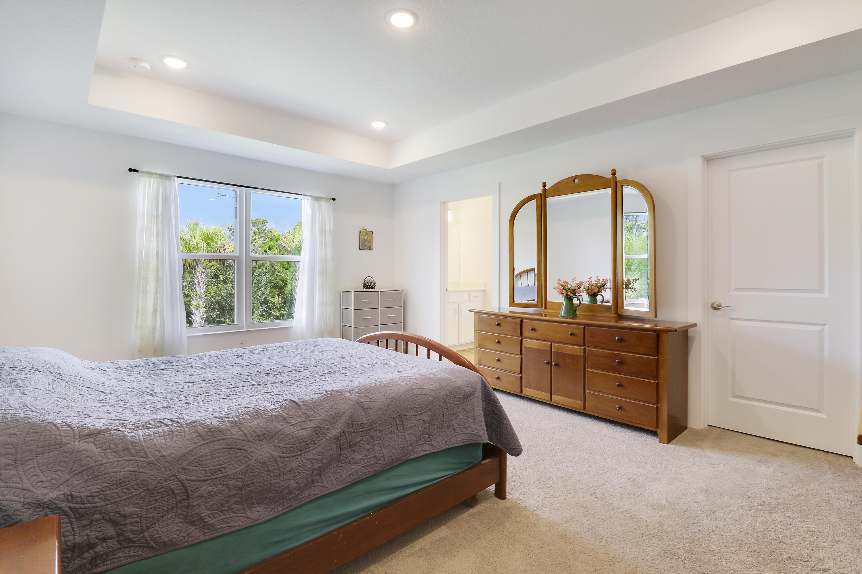 1416 Gopher Terrace Stuart, FL 34994 - Photo 16 of 53 a bedroom with a bed and a dresser