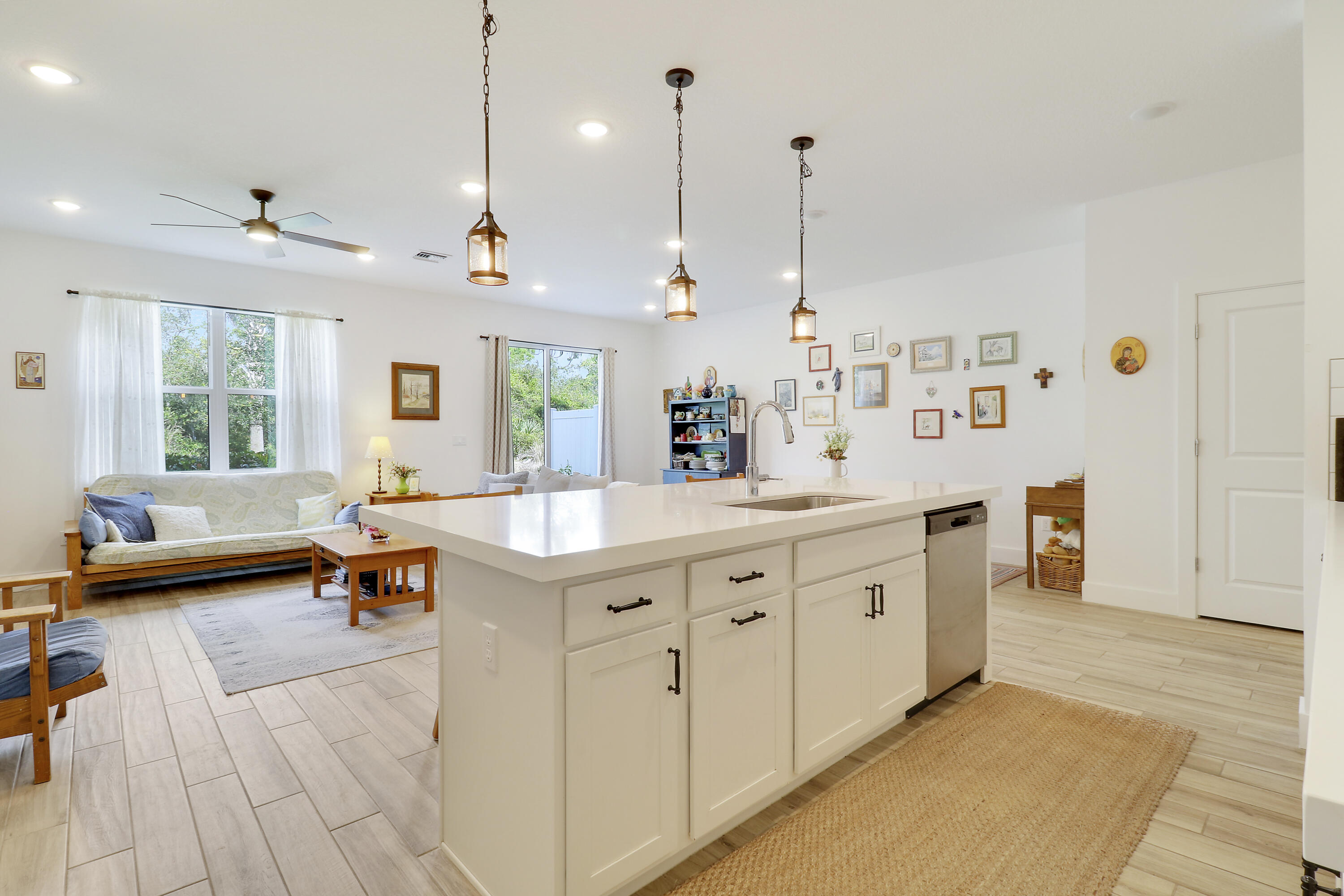 1416 Gopher Terrace Stuart, FL 34994 - Photo 6 of 53 a kitchen with sink stove and living room