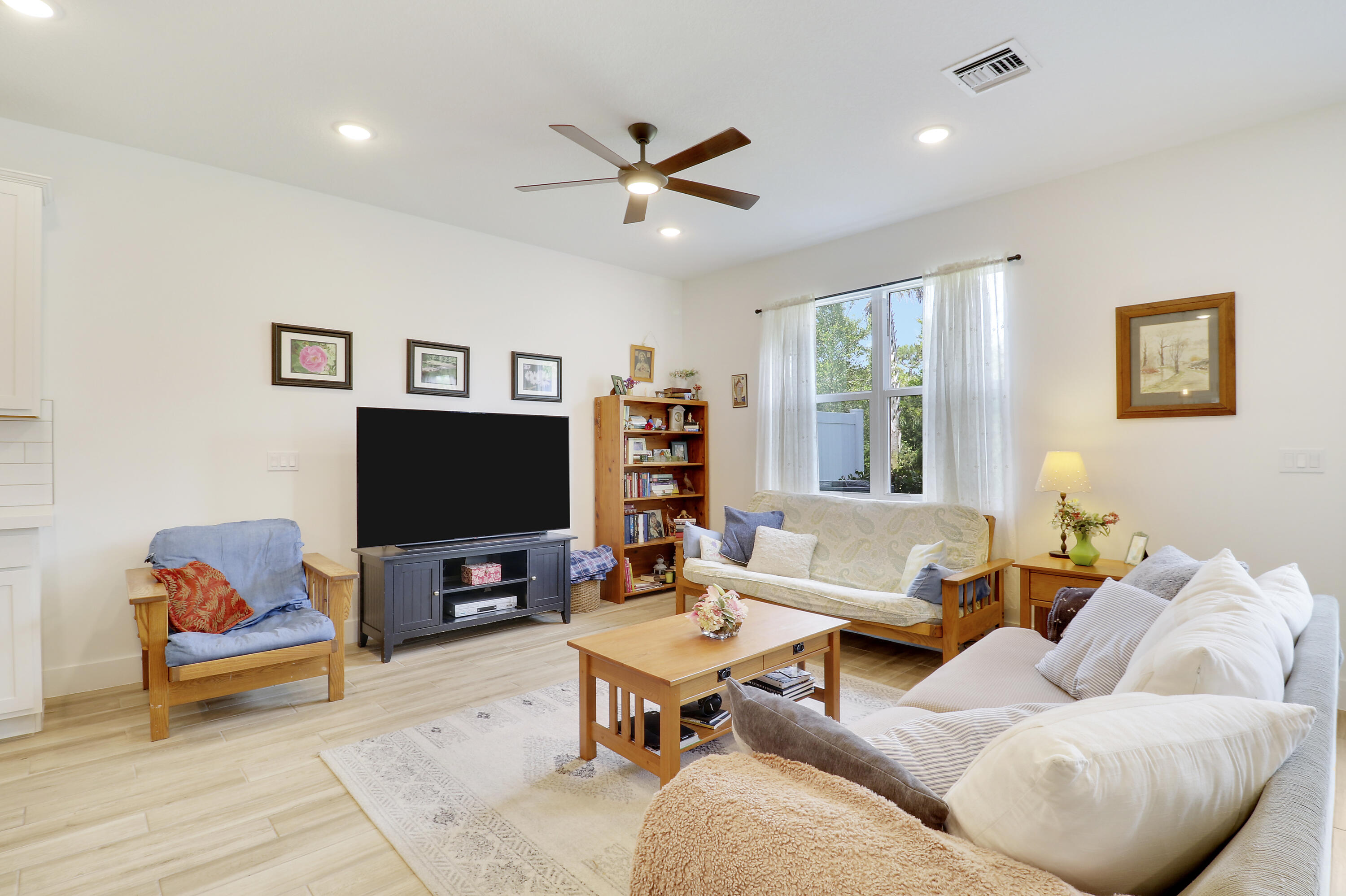 1416 Gopher Terrace Stuart, FL 34994 - Photo 9 of 53 a living room with furniture and a flat screen tv with wooden floor