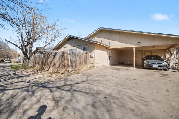 a view of a house with a yard and garage