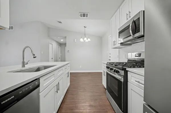a view of a kitchen sink and cabinets