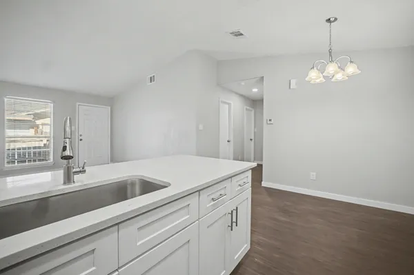 a view of a house with a big yard and large trees
