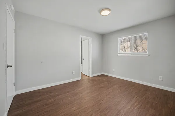a bathroom with a sink a toilet a mirror and shower