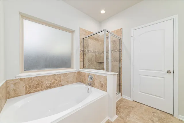 a bathroom with a bathtub and a shower