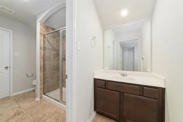a bathroom with a shower sink and mirror