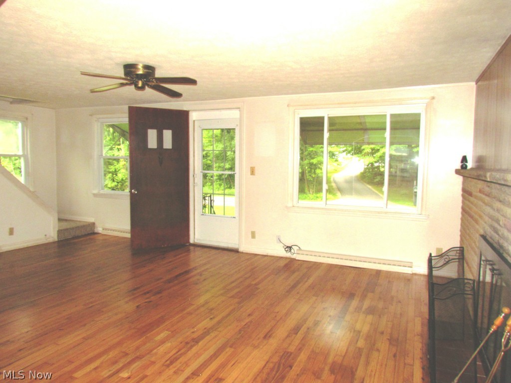 16339 Snow Road Burton, OH 44021 - Photo 4 of 16 Large living room with fireplace. Gleaming hardwood floors just refinished August 2014