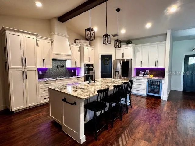 a open kitchen with stainless steel appliances granite countertop a stove and refrigerator