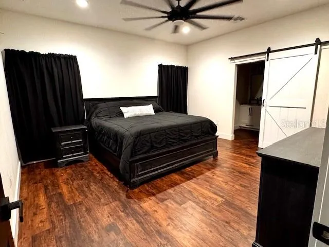a bedroom with a bed dresser and a window