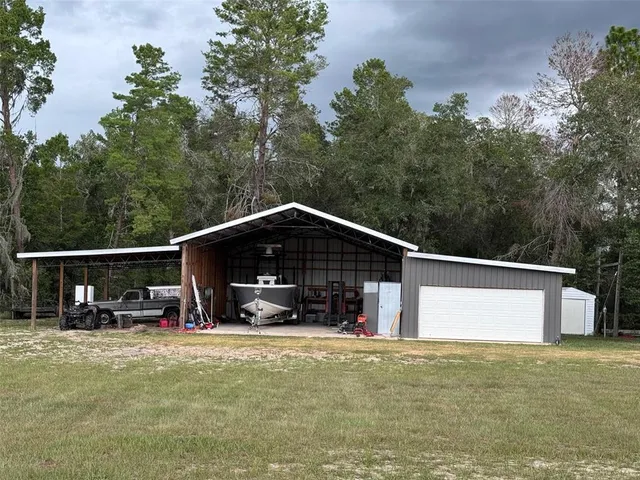 a view of a wooden roof and trees in the background