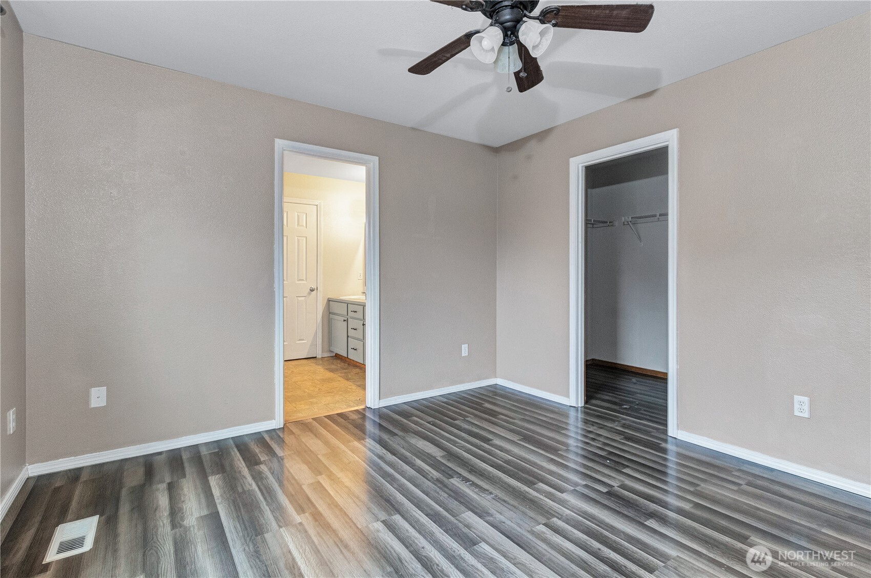 7027 Bailey Street Southeast Lacey, WA 98513 - Photo 13 of 27 a view of an empty room with wooden floor and a window