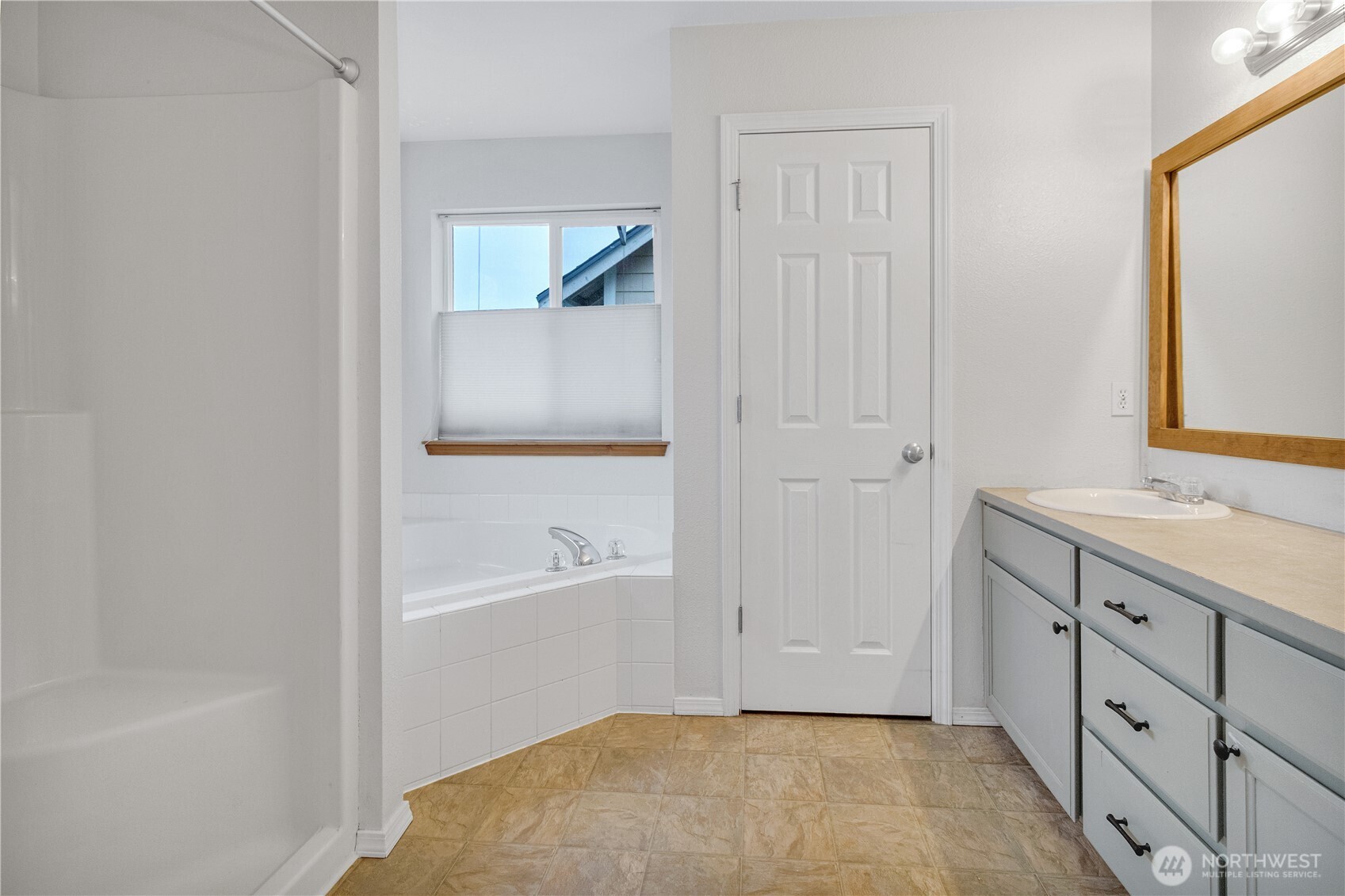 7027 Bailey Street Southeast Lacey, WA 98513 - Photo 15 of 27 a bathroom with a tub sink and a mirror