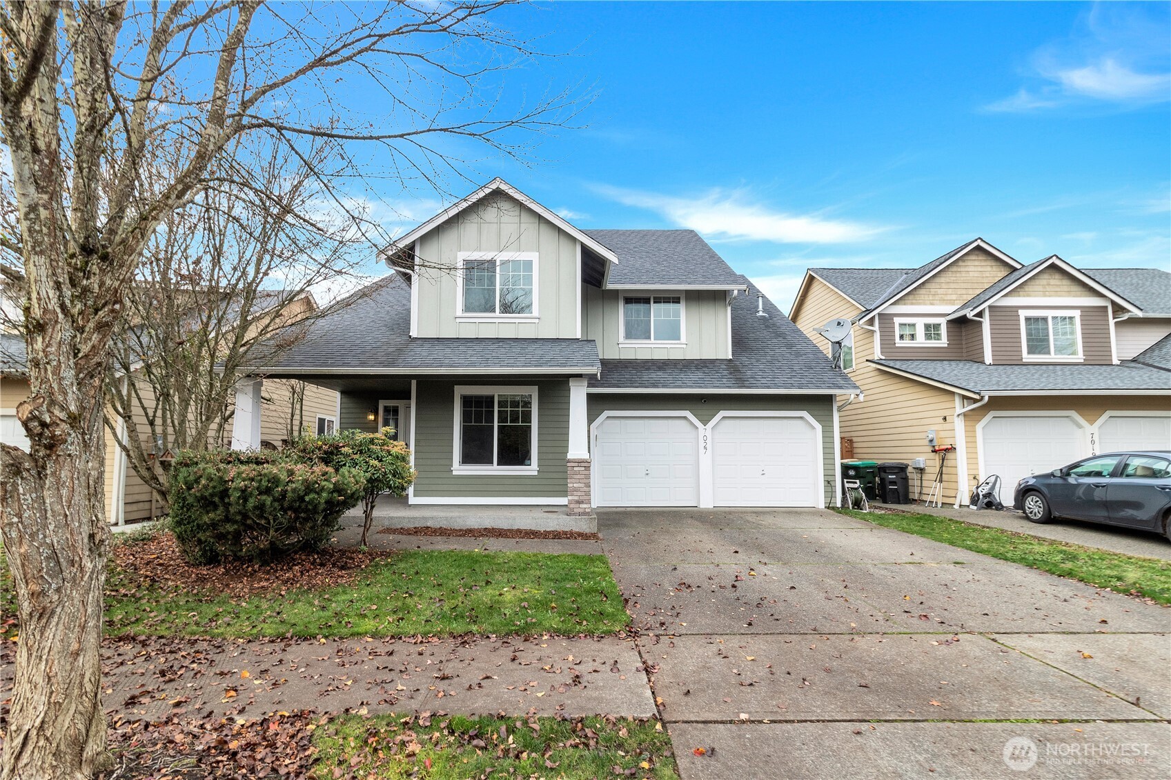 7027 Bailey Street Southeast Lacey, WA 98513 - Photo 2 of 27 a front view of a house with a yard and garage
