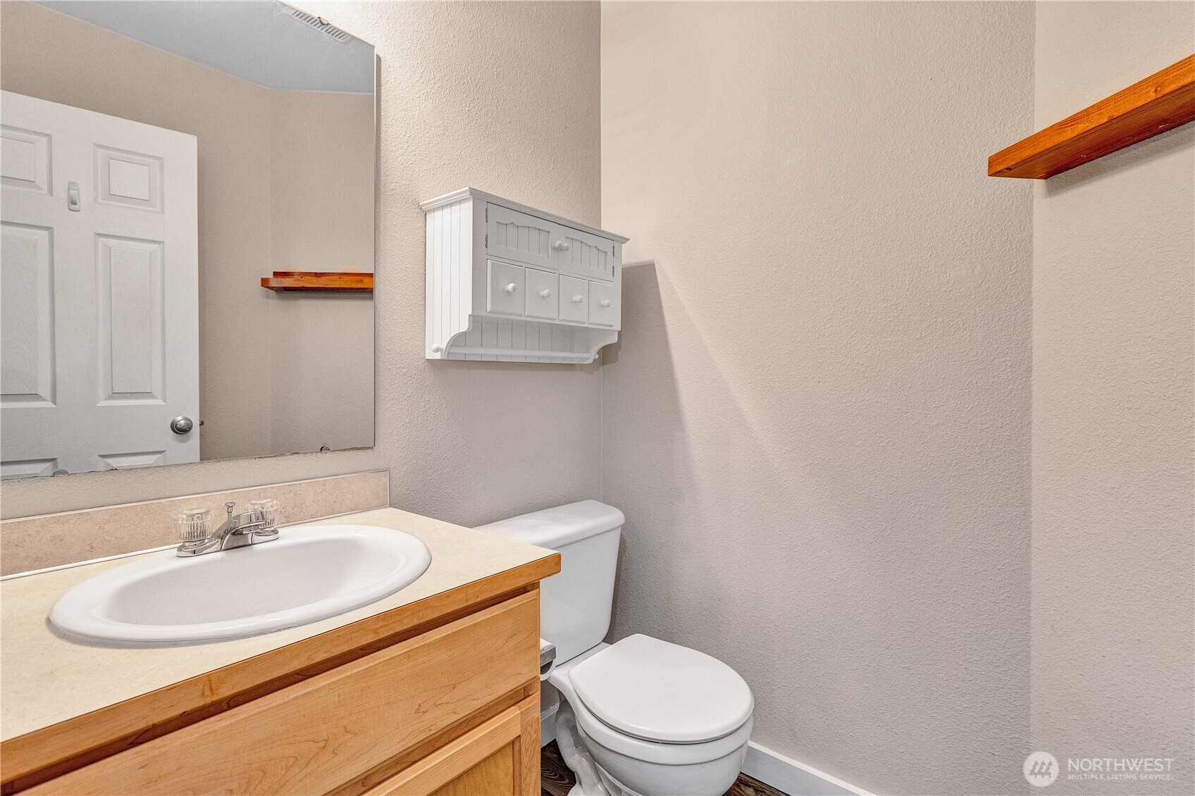 7027 Bailey Street Southeast Lacey, WA 98513 - Photo 25 of 27 a bathroom with a sink toilet and vanity