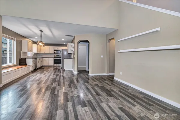 a view of a room with wooden floor