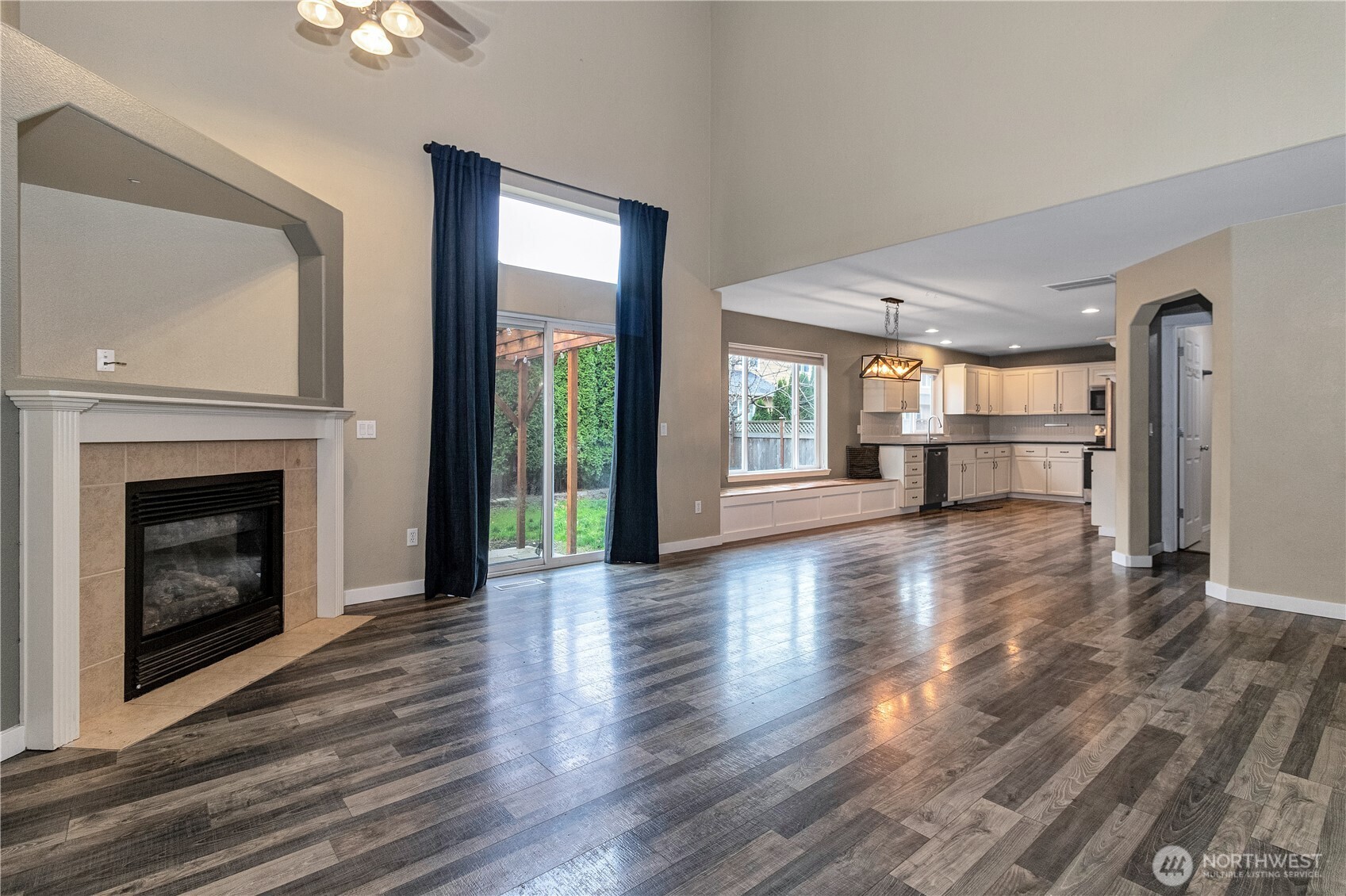 7027 Bailey Street Southeast Lacey, WA 98513 - Photo 6 of 27 a view of a livingroom with wooden floor a fireplace and window