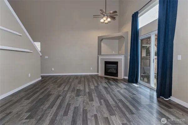 wooden floor fireplace and natural light in room