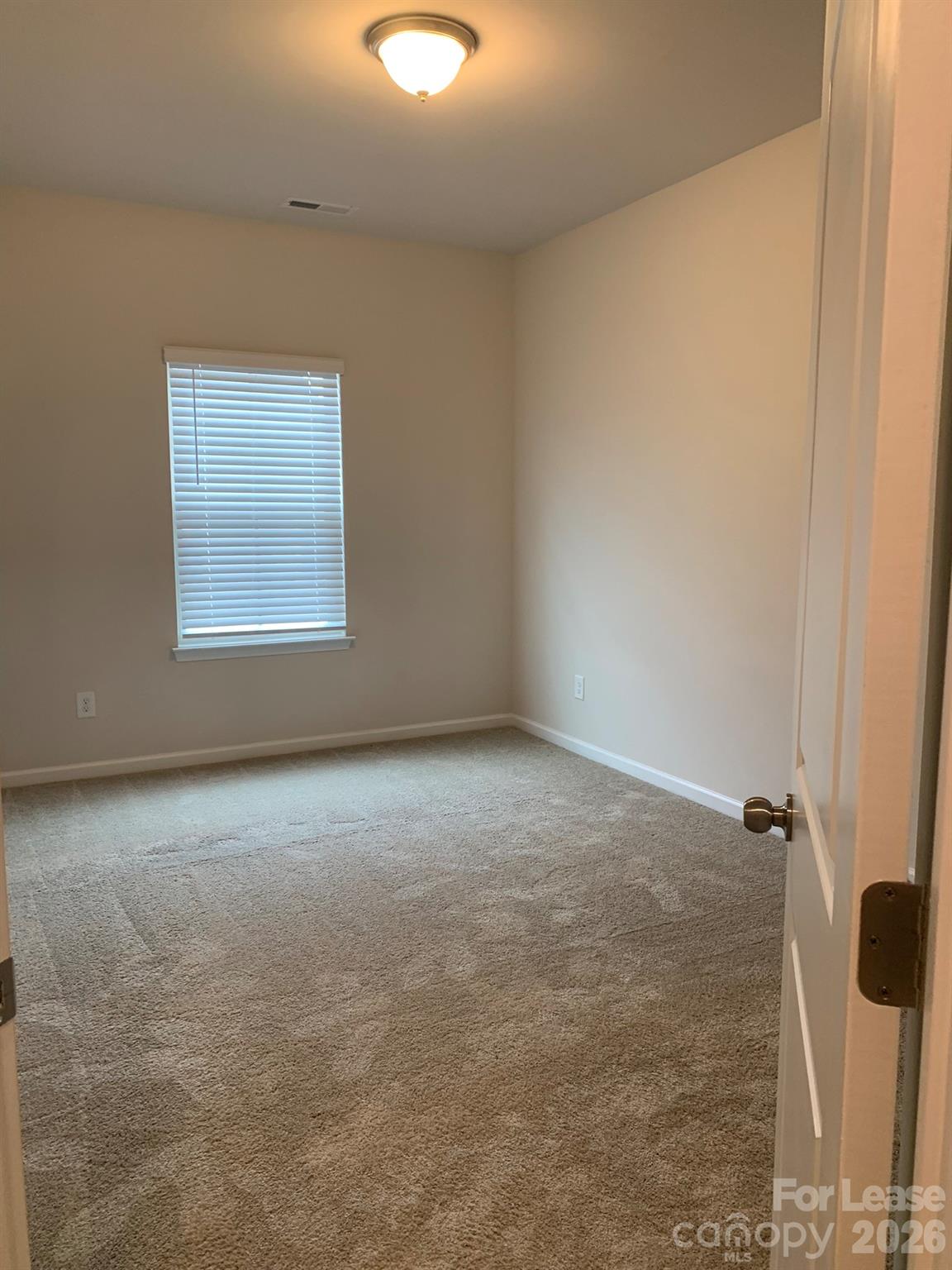 2143 Stevens Mill Road Matthews, NC 28104 - Photo 31 of 39 an empty room with a empty space and a window