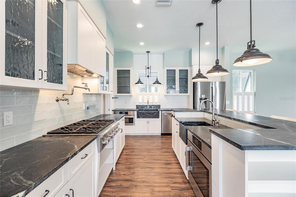 9691 Southwest Anchor Arcadia, FL 34269 - Photo 22 of 74 a kitchen with stainless steel appliances granite countertop a stove a sink a refrigerator and a granite counter tops
