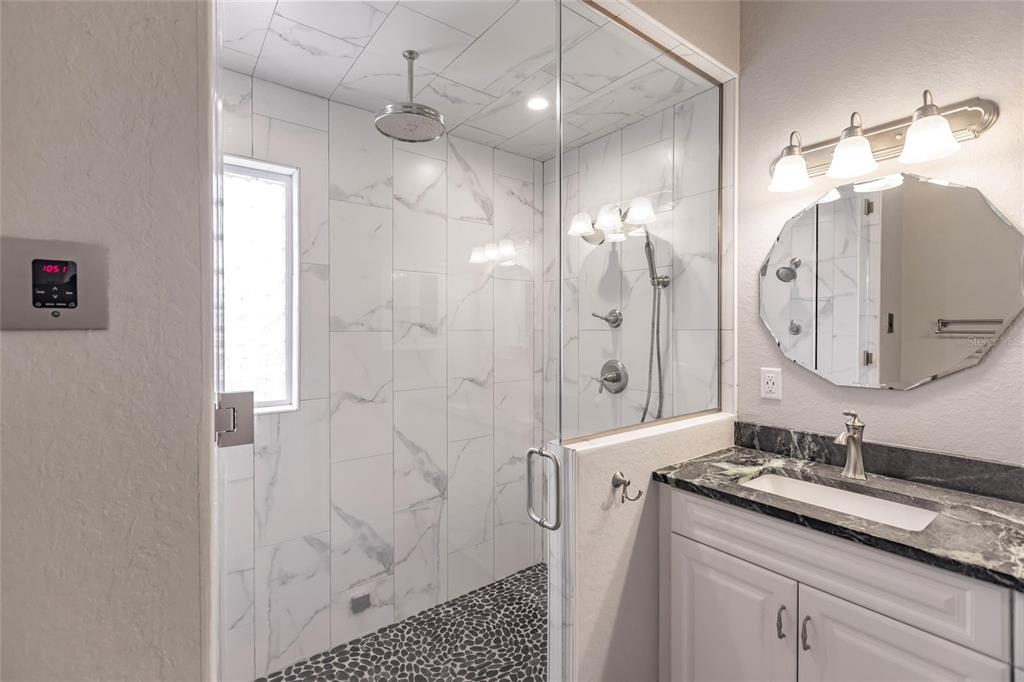 9691 Southwest Anchor Arcadia, FL 34269 - Photo 38 of 74 a bathroom with a double vanity sink mirror and shower