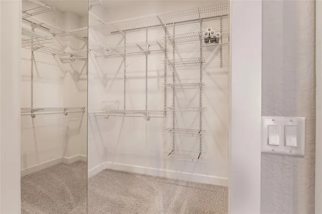 a bathroom with a granite countertop toilet sink and mirror