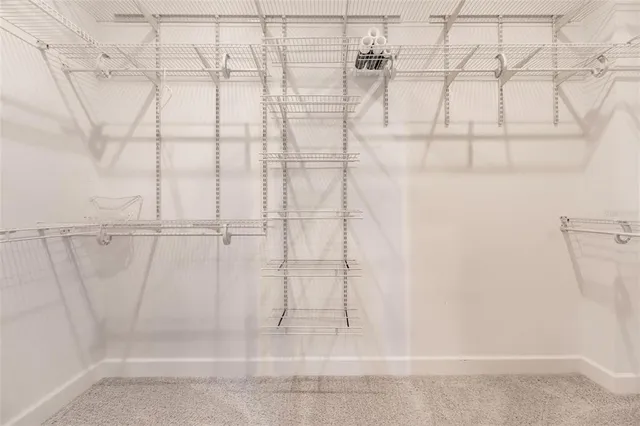 a bathroom with a granite countertop toilet sink and mirror