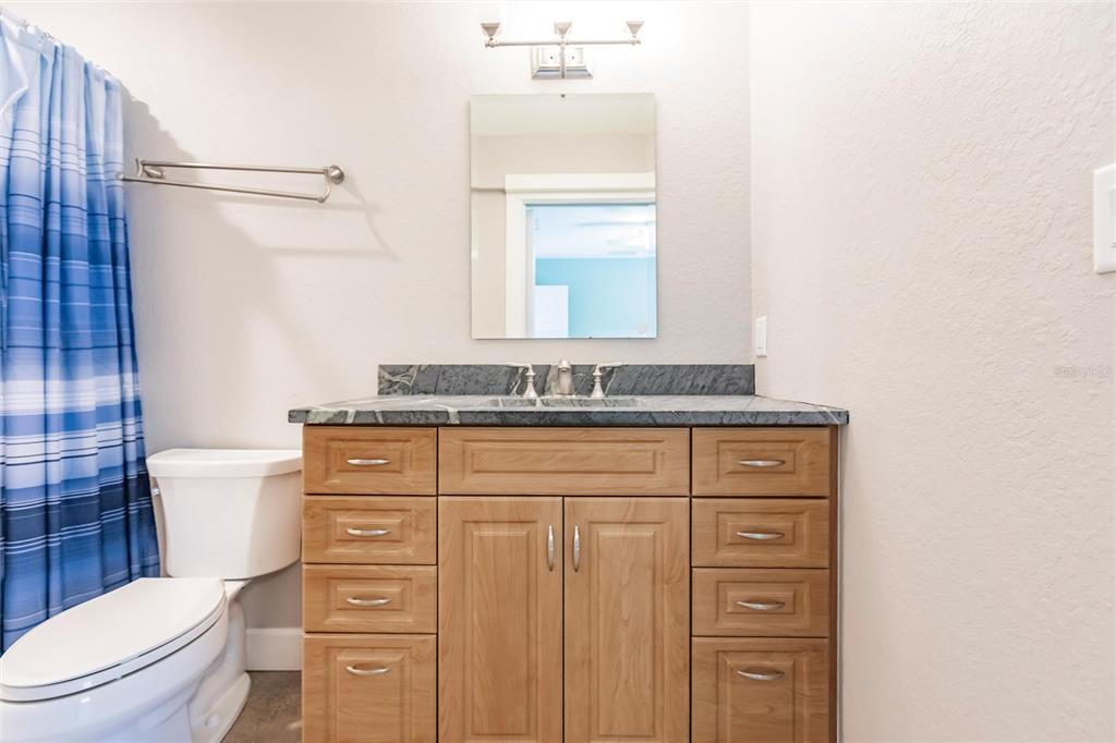 9691 Southwest Anchor Arcadia, FL 34269 - Photo 56 of 74 a bathroom with a granite countertop toilet sink and mirror