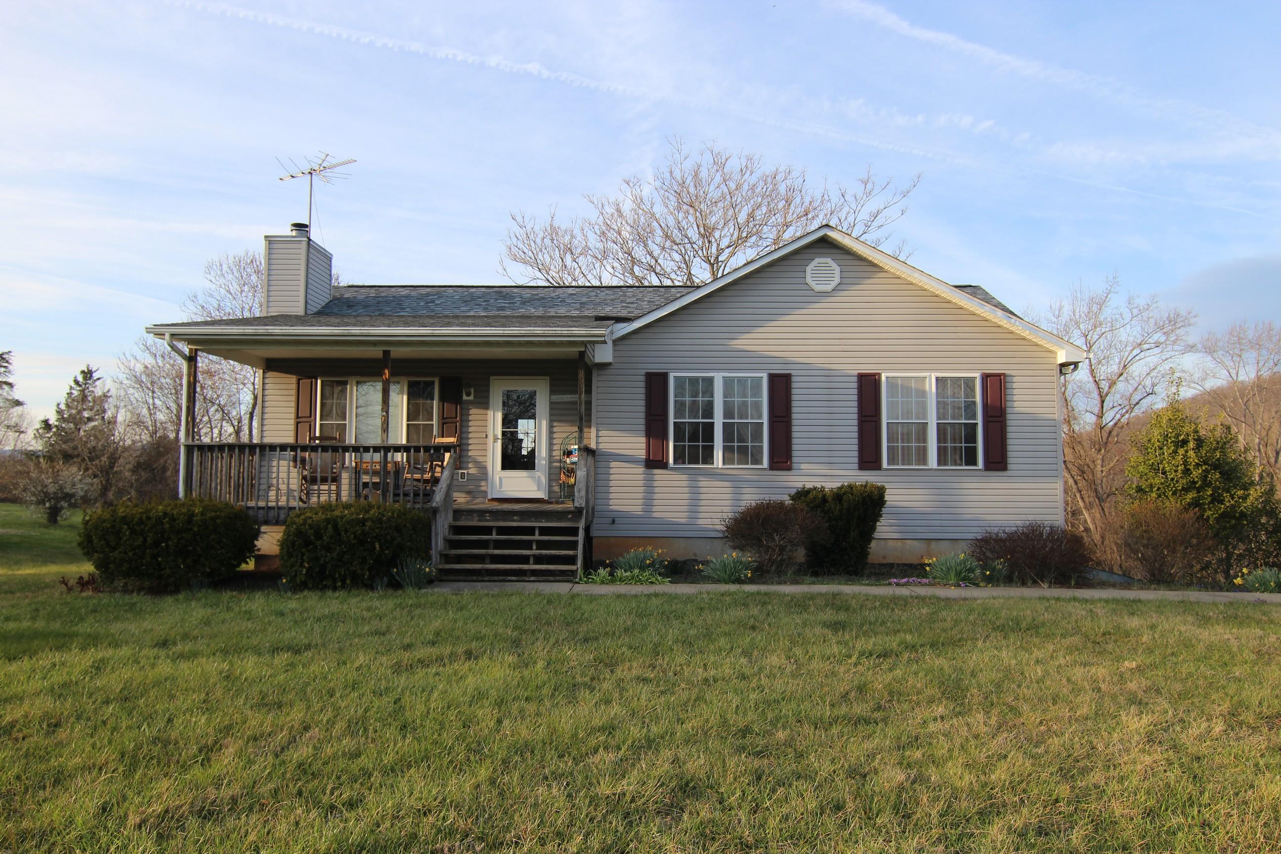 6878 Goodview Road Goodview, VA 24095 - Photo 1 of 15 a front view of a house with garden