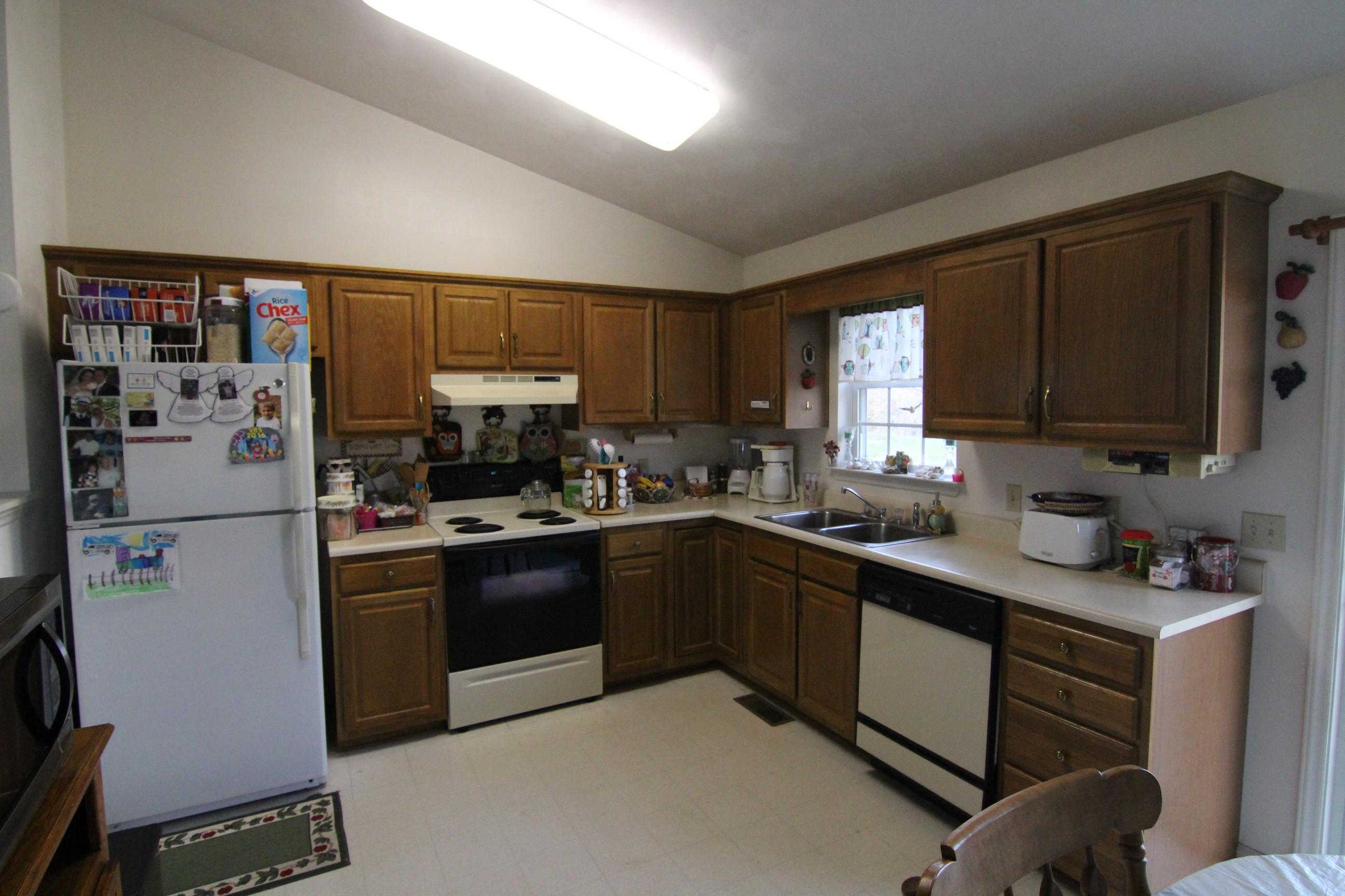 6878 Goodview Road Goodview, VA 24095 - Photo 2 of 15 a kitchen with stainless steel appliances granite countertop a refrigerator stove and a sink