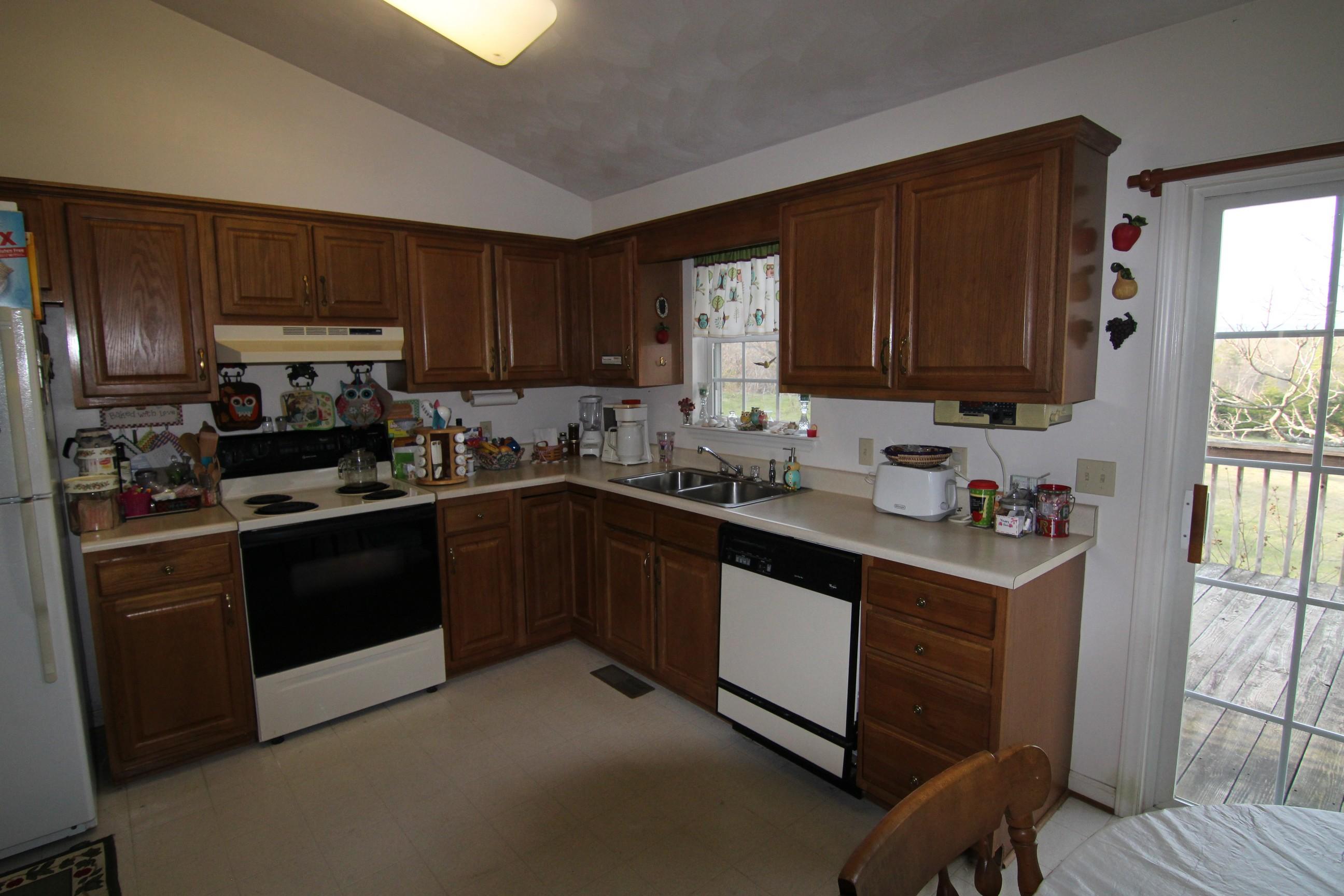 6878 Goodview Road Goodview, VA 24095 - Photo 3 of 15 a kitchen with stainless steel appliances granite countertop a stove a sink dishwasher and a refrigerator