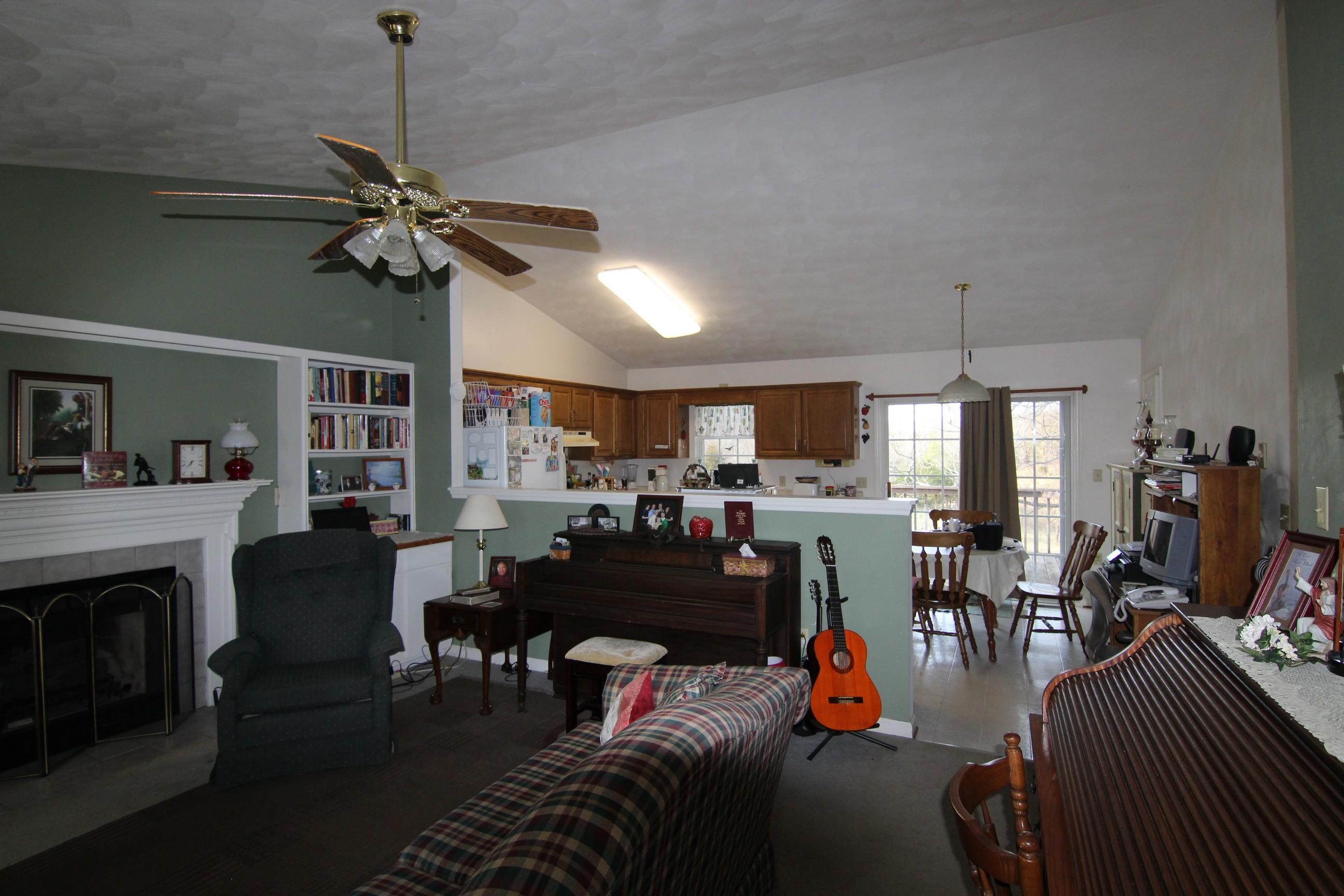 6878 Goodview Road Goodview, VA 24095 - Photo 5 of 15 a living room with furniture a flat screen tv and a fireplace