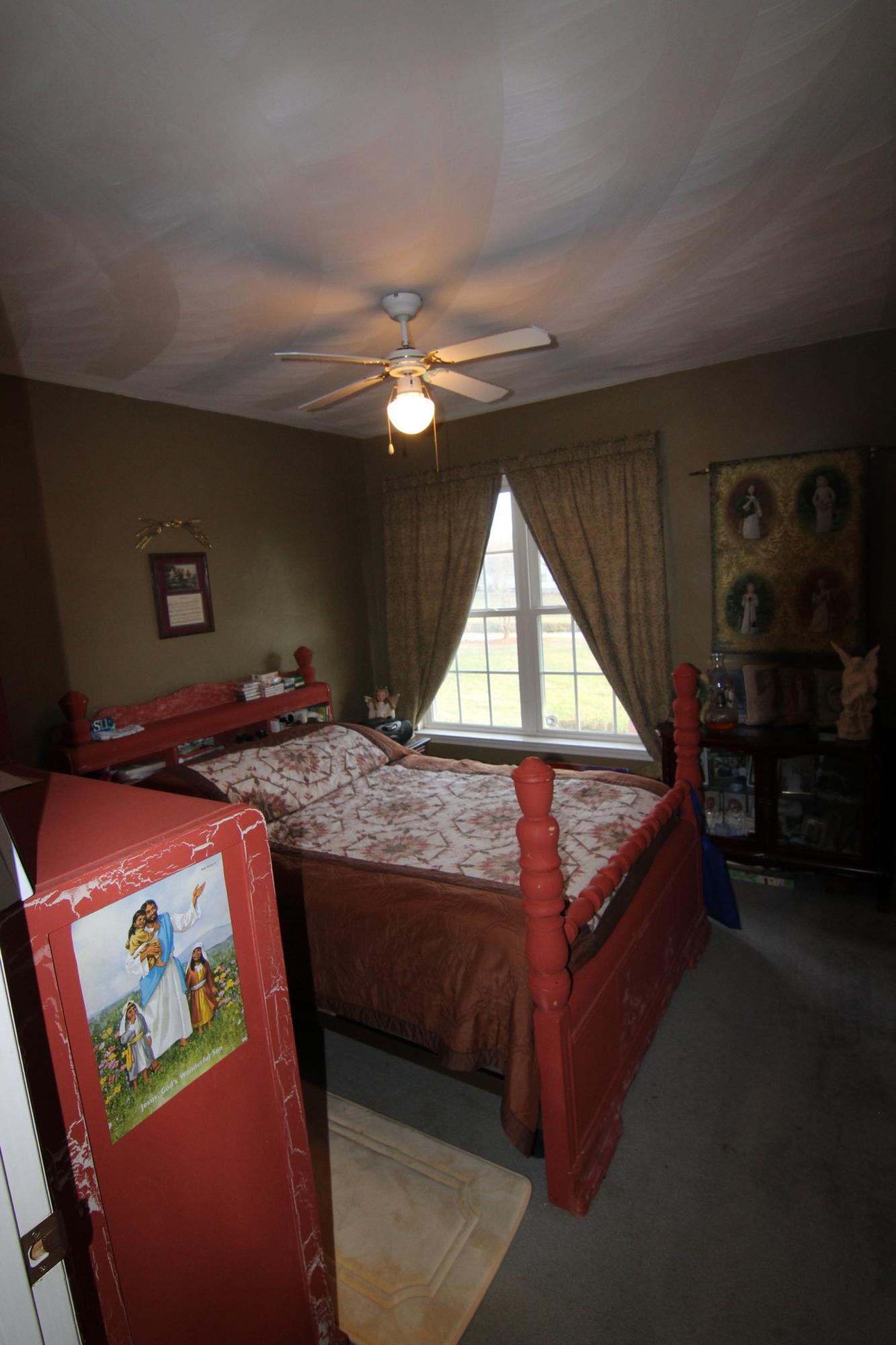6878 Goodview Road Goodview, VA 24095 - Photo 6 of 15 a bedroom with a bed and a chandelier
