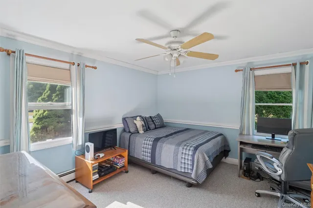 a bedroom with a bed a window and a couch