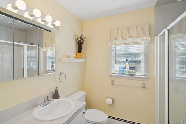a white toilet sitting next to a bathroom sink
