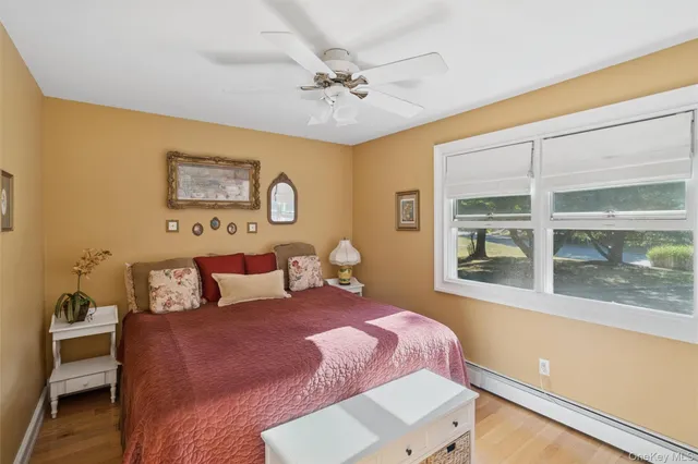 a bedroom with a bed and a large window with the outer view