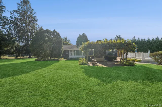 a view of a house with backyard and a garden