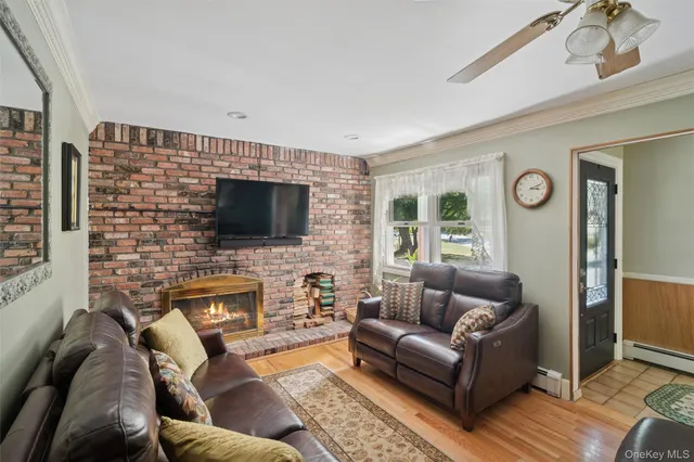 a living room with fireplace furniture and a flat screen tv