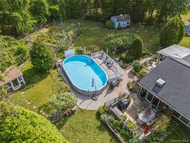 an aerial view of a house with a garden and swimming pool