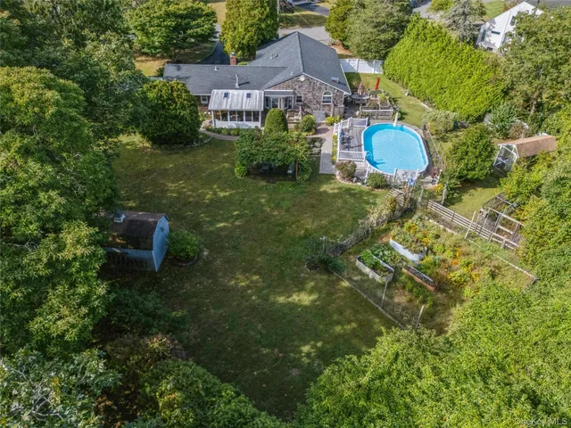 a aerial view of a house with yard swimming pool and outdoor seating
