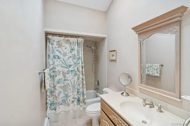 a bathroom with a sink a toilet and shower curtain