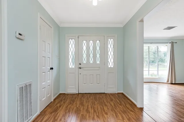 wooden floor in an empty room with a window